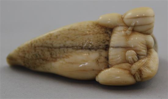 A Japanese ivory netsuke of a man riding an earthquake fish, Edo period, 4.7cm